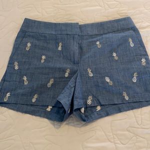 Denim shorts with gold pineapples.